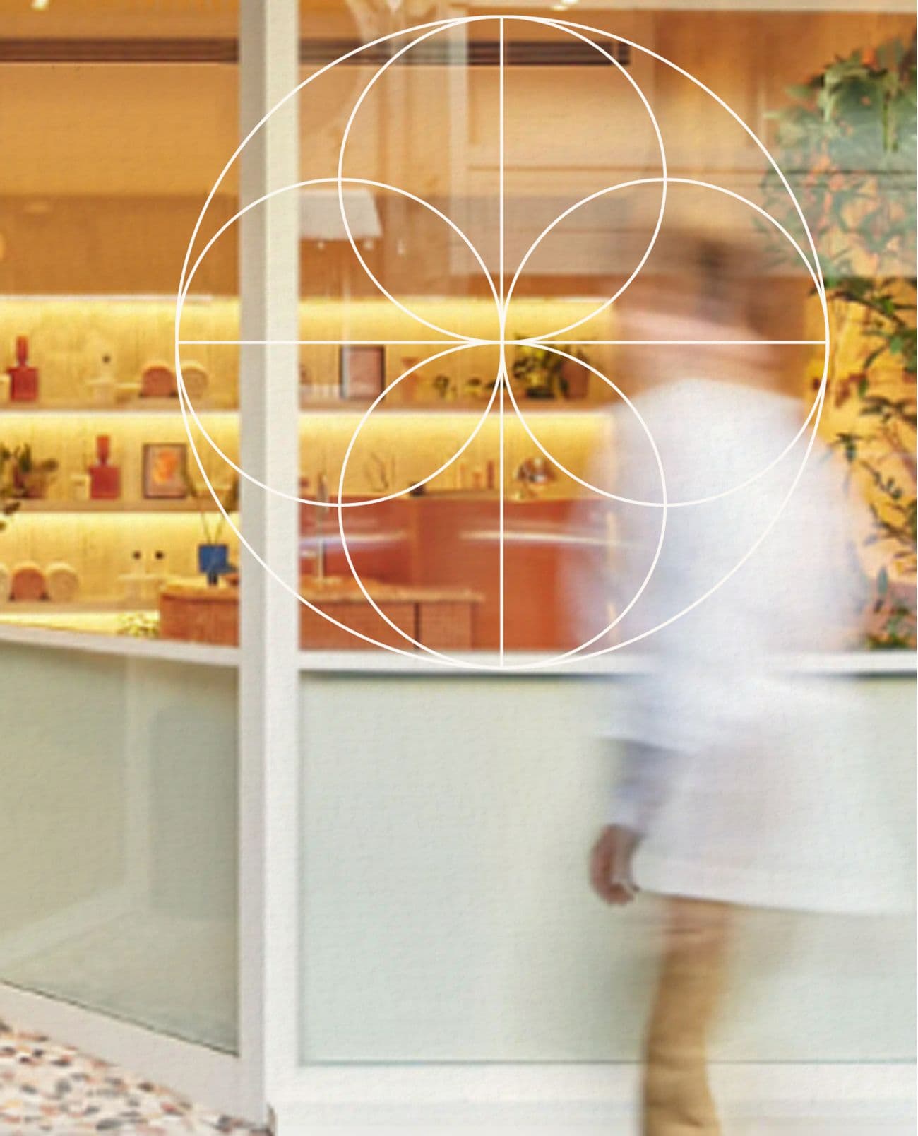 Clinic reception with warm shelving and a blurred figure walking by